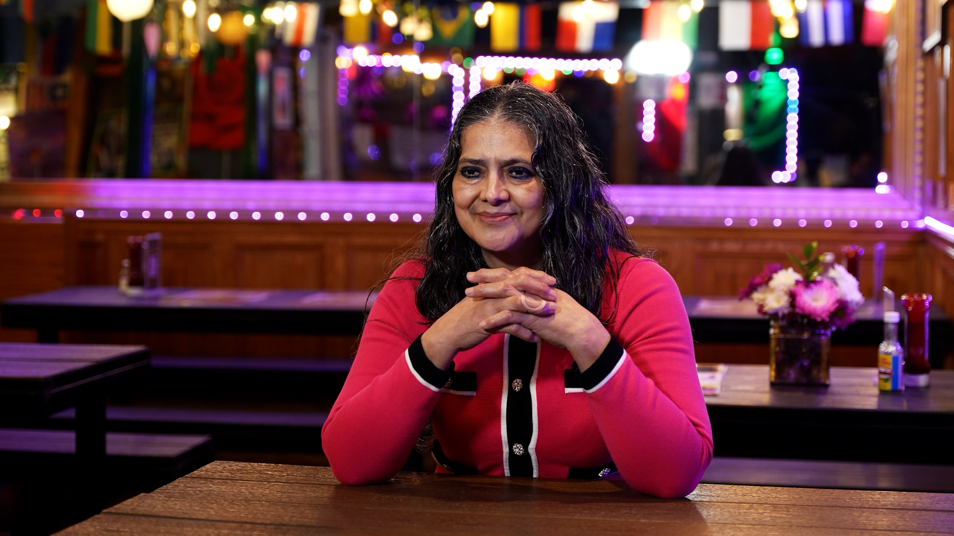 Haydee Vanegas sitting at a table in her restaurant